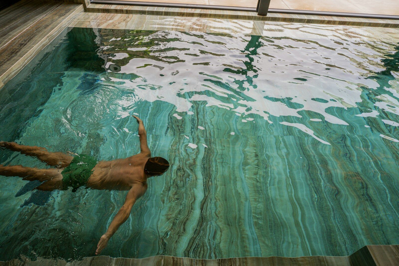 A man swimming in a pool of water